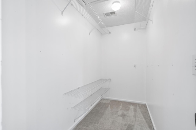 walk in closet featuring carpet flooring and visible vents