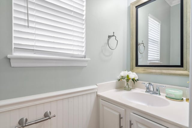 bathroom with a wainscoted wall and vanity