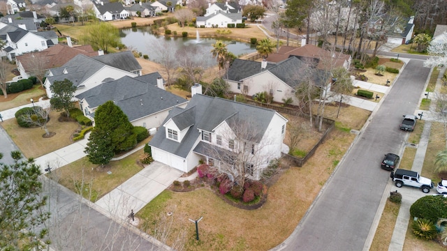 drone / aerial view featuring a residential view and a water view