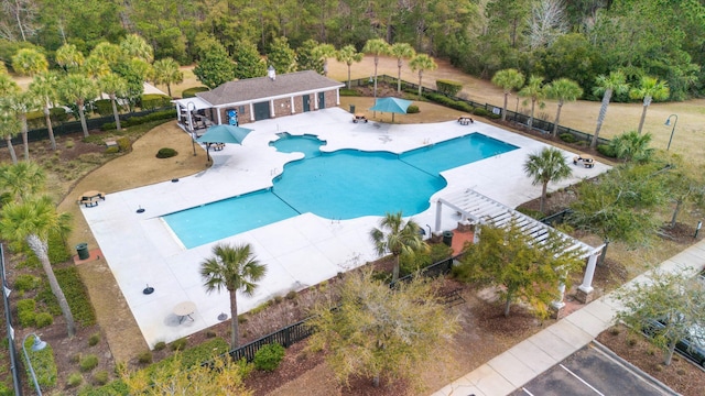 pool featuring fence and a patio area