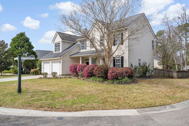 view of front of house with a garage, driveway, a front lawn, and fence