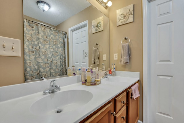 bathroom with a textured ceiling and vanity