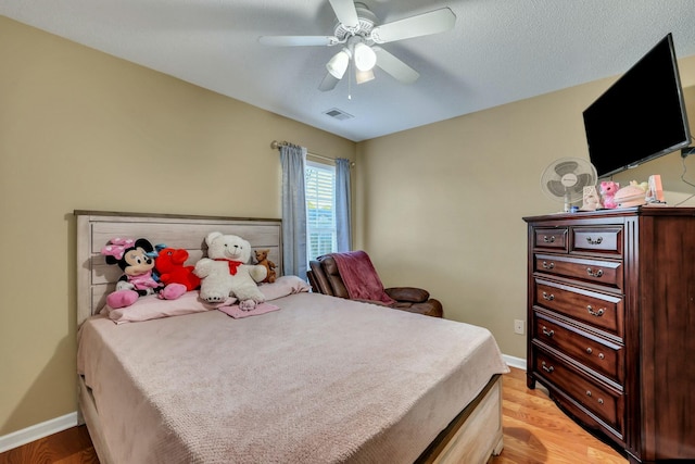 bedroom with ceiling fan and light hardwood / wood-style flooring