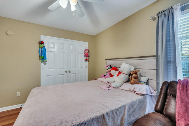 bedroom with ceiling fan, a closet, and wood-type flooring