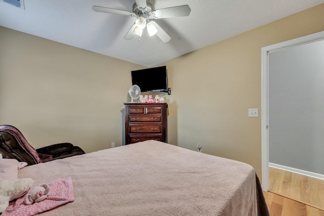 bedroom featuring ceiling fan and hardwood / wood-style floors