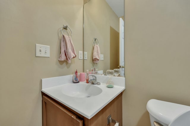 bathroom featuring toilet and vanity