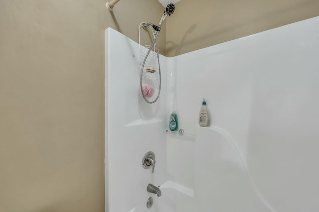 interior details with shower / bath combination