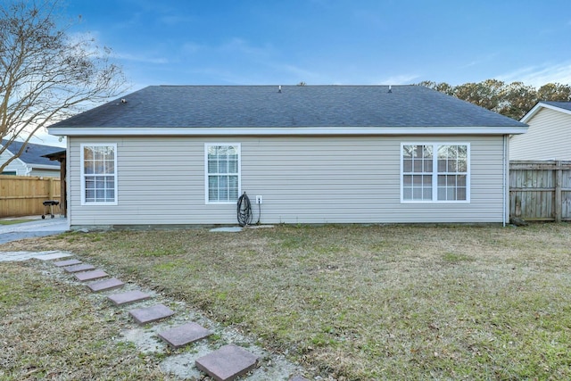 rear view of house with a yard