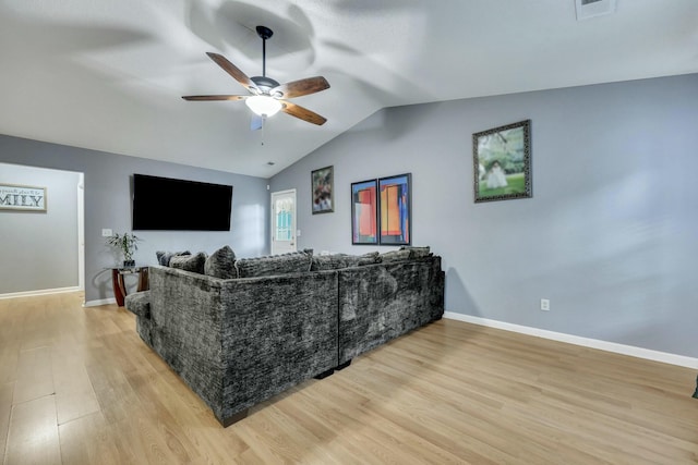 living room featuring ceiling fan, lofted ceiling, and light wood-type flooring