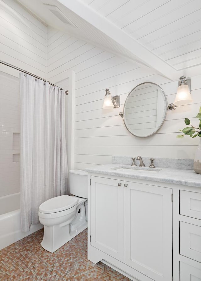 full bathroom featuring beam ceiling, vanity, shower / bathtub combination with curtain, and wooden walls