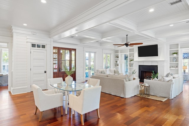 dining space featuring coffered ceiling, built in shelves, ceiling fan, hardwood / wood-style flooring, and beamed ceiling