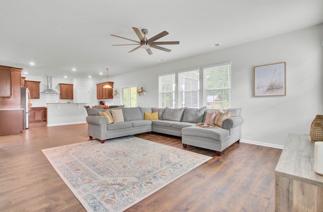 living room with ceiling fan and dark wood-type flooring