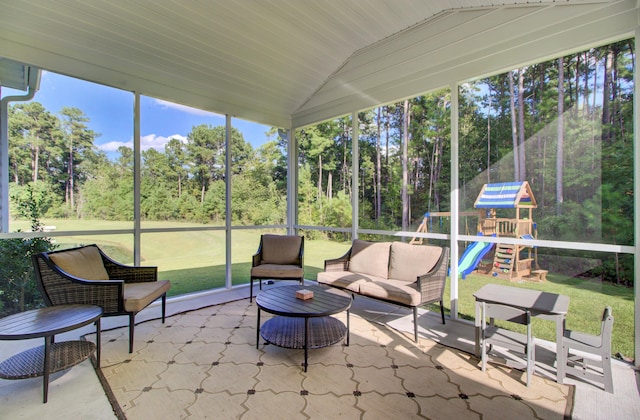 sunroom with plenty of natural light and lofted ceiling