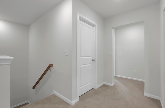 hallway with light colored carpet