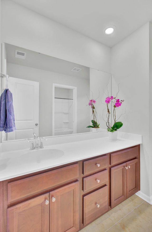 bathroom featuring tile patterned flooring and vanity