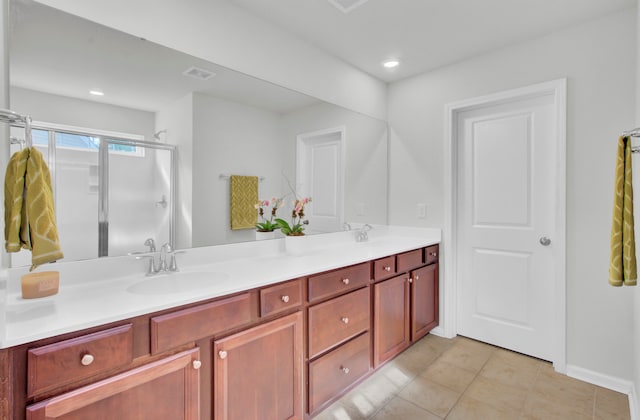 bathroom featuring vanity, tile patterned floors, and a shower with shower door