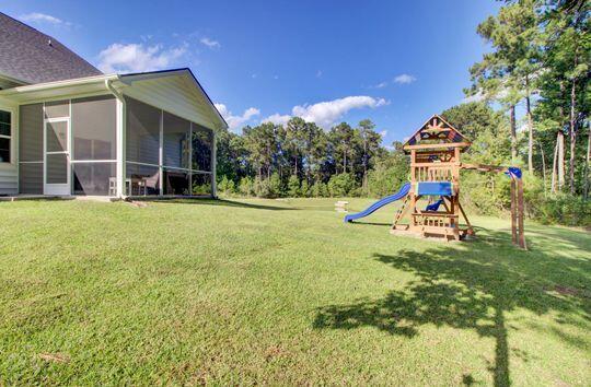 view of yard featuring a playground and a sunroom