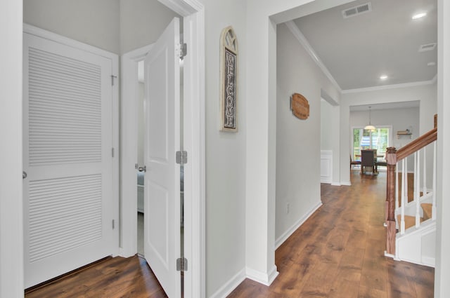 hall featuring dark hardwood / wood-style floors and ornamental molding