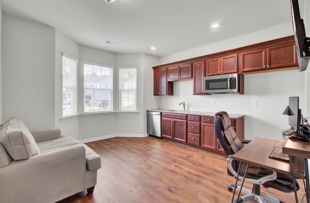 office space with sink and wood-type flooring