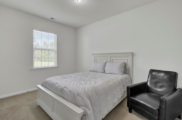 bedroom featuring light carpet