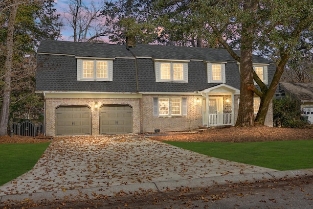 view of front facade with a garage and a yard