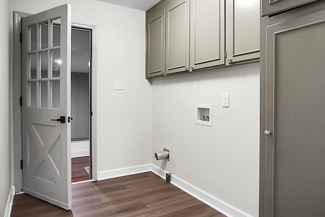 laundry room featuring washer hookup, dark hardwood / wood-style floors, and cabinets