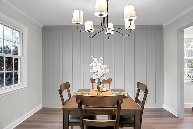 dining room featuring crown molding, a healthy amount of sunlight, and dark wood-type flooring