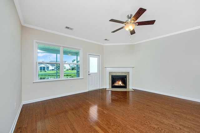 unfurnished living room with ceiling fan, hardwood / wood-style floors, and ornamental molding