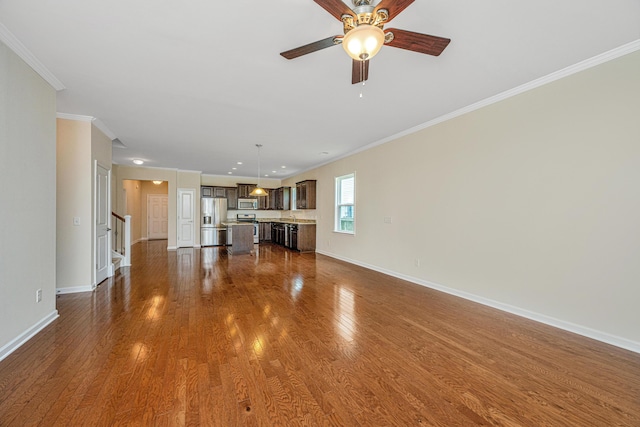 unfurnished living room with ceiling fan, crown molding, and dark wood-type flooring