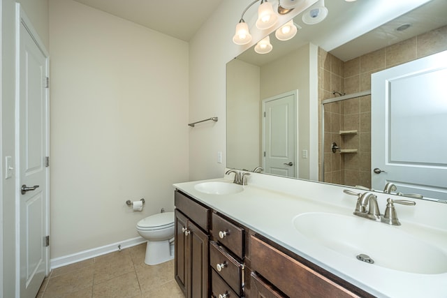 bathroom featuring tile patterned floors, double sink vanity, and toilet