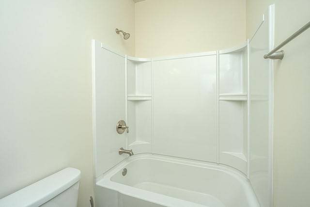 bathroom featuring shower / tub combination and toilet