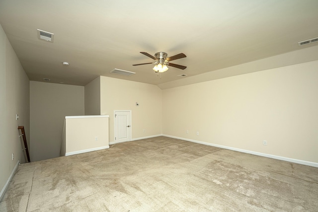 spare room with ceiling fan and light carpet