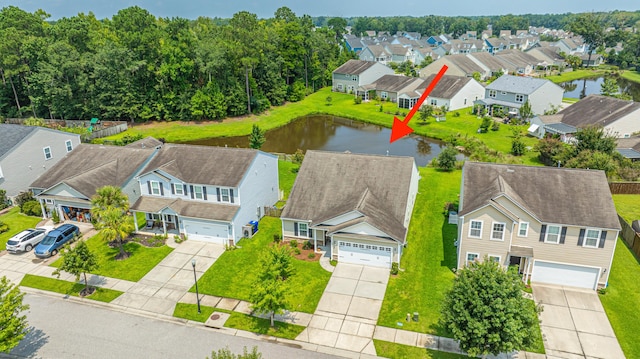 birds eye view of property with a water view