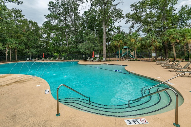 view of pool featuring a playground and pool water feature