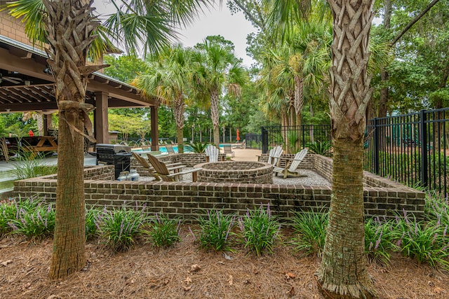 view of swimming pool with a patio area, a grill, and a fire pit