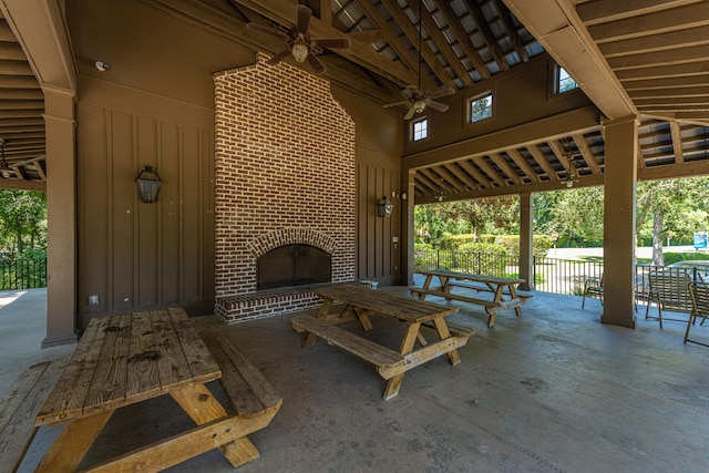 view of patio featuring ceiling fan and an outdoor brick fireplace