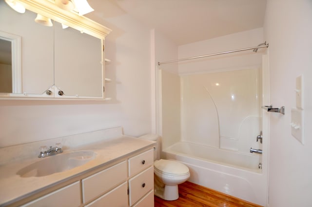 bathroom with toilet, shower / bathtub combination, wood finished floors, and vanity
