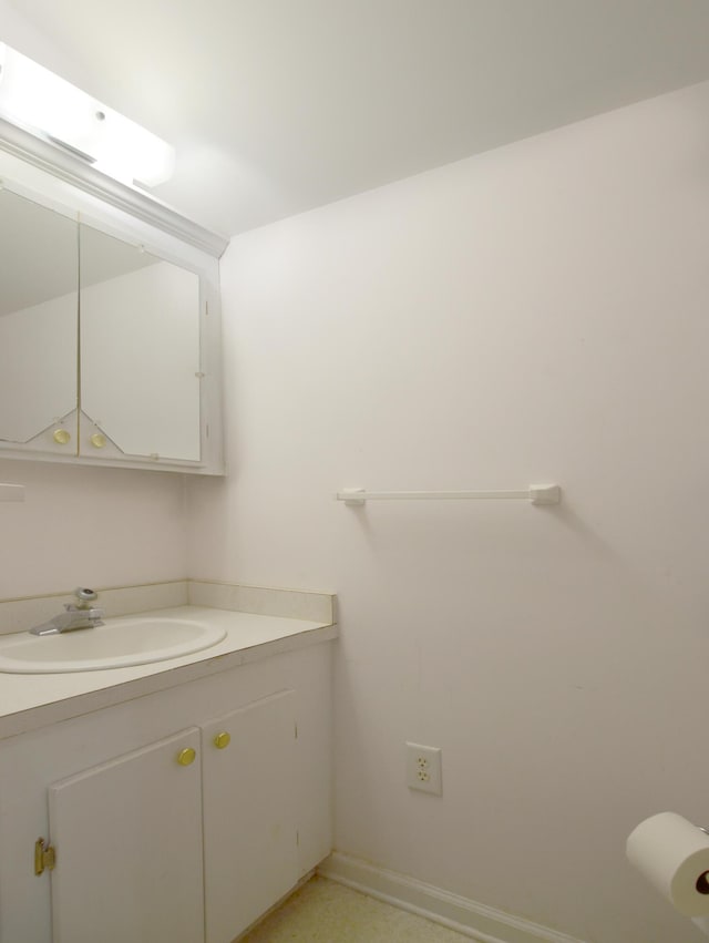 bathroom with baseboards and vanity