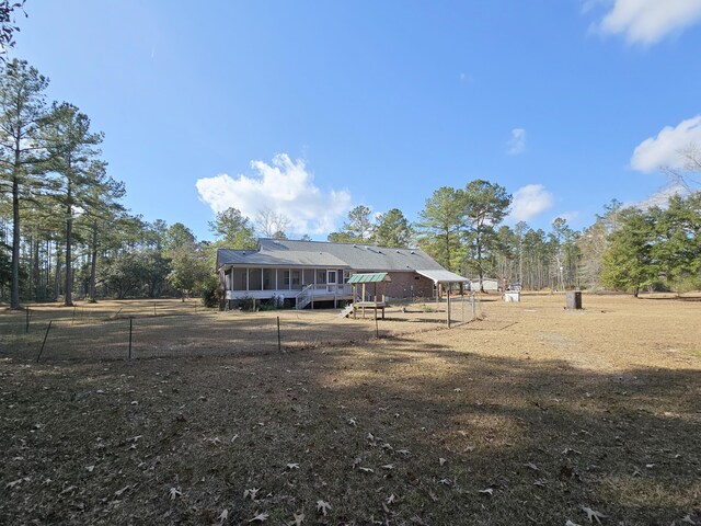 exterior space with a sunroom and fence