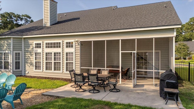 144 Back Tee Cir, Summerville, SC 29485 - rear view of house with a sunroom, roof with shingles, fence, a patio, and a chimney