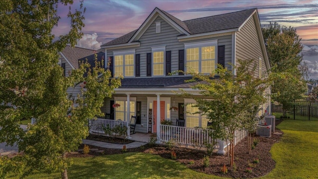 144 Back Tee Cir, Summerville, SC 29485 - traditional home with a lawn, covered porch, fence, and roof with shingles