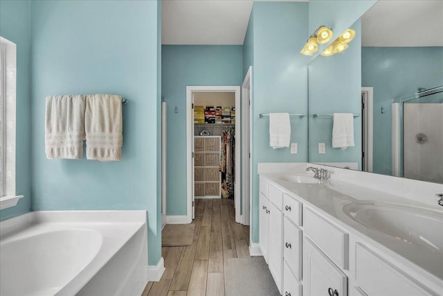 144 Back Tee Cir, Summerville, SC 29485 - full bathroom with a stall shower, a sink, wood finished floors, a spacious closet, and a bath
