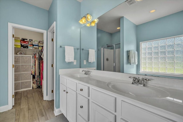 144 Back Tee Cir, Summerville, SC 29485 - bathroom featuring wood finished floors, a sink, a stall shower, and visible vents
