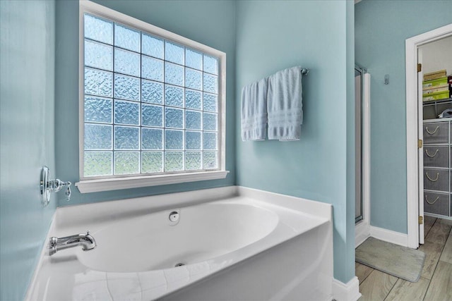 144 Back Tee Cir, Summerville, SC 29485 - bathroom featuring a stall shower, baseboards, a garden tub, and wood finished floors