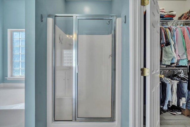 144 Back Tee Cir, Summerville, SC 29485 - bathroom with a bath, a spacious closet, a shower stall, and plenty of natural light