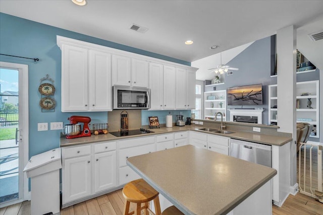 144 Back Tee Cir, Summerville, SC 29485 - kitchen with a sink, light wood-type flooring, white cabinets, and appliances with stainless steel finishes