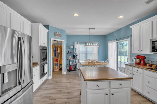 144 Back Tee Cir, Summerville, SC 29485 - kitchen with white cabinets, a kitchen island, black appliances, and wood tiled floor