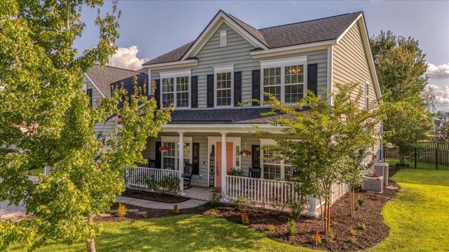 144 Back Tee Cir, Summerville, SC 29485 - view of front of house with a shingled roof, fence, a porch, and a front yard