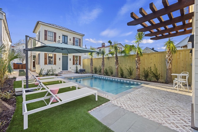 view of pool featuring a patio, a fenced in pool, a fenced backyard, and a pergola