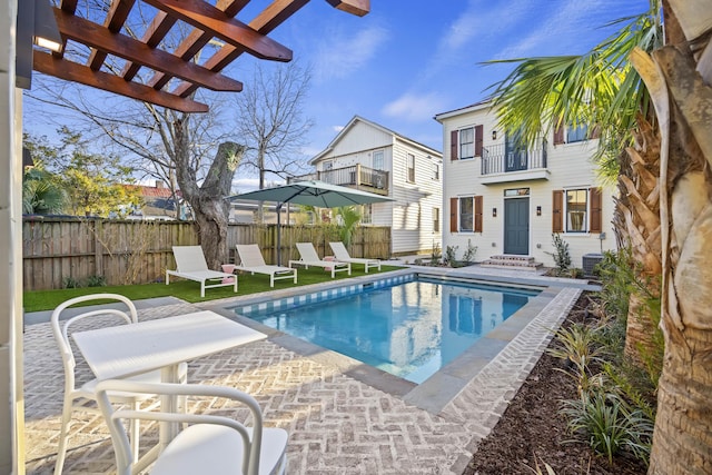 view of swimming pool featuring a fenced in pool, a pergola, and fence